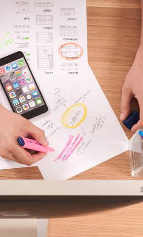 Top view of someone making plans at his desk.